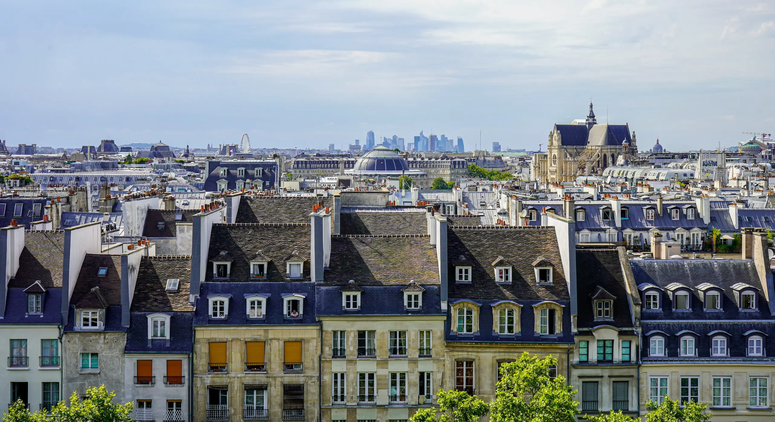 suburban skyline with city skyline in the background, bubbles with icons floating in the air showing the services we provide