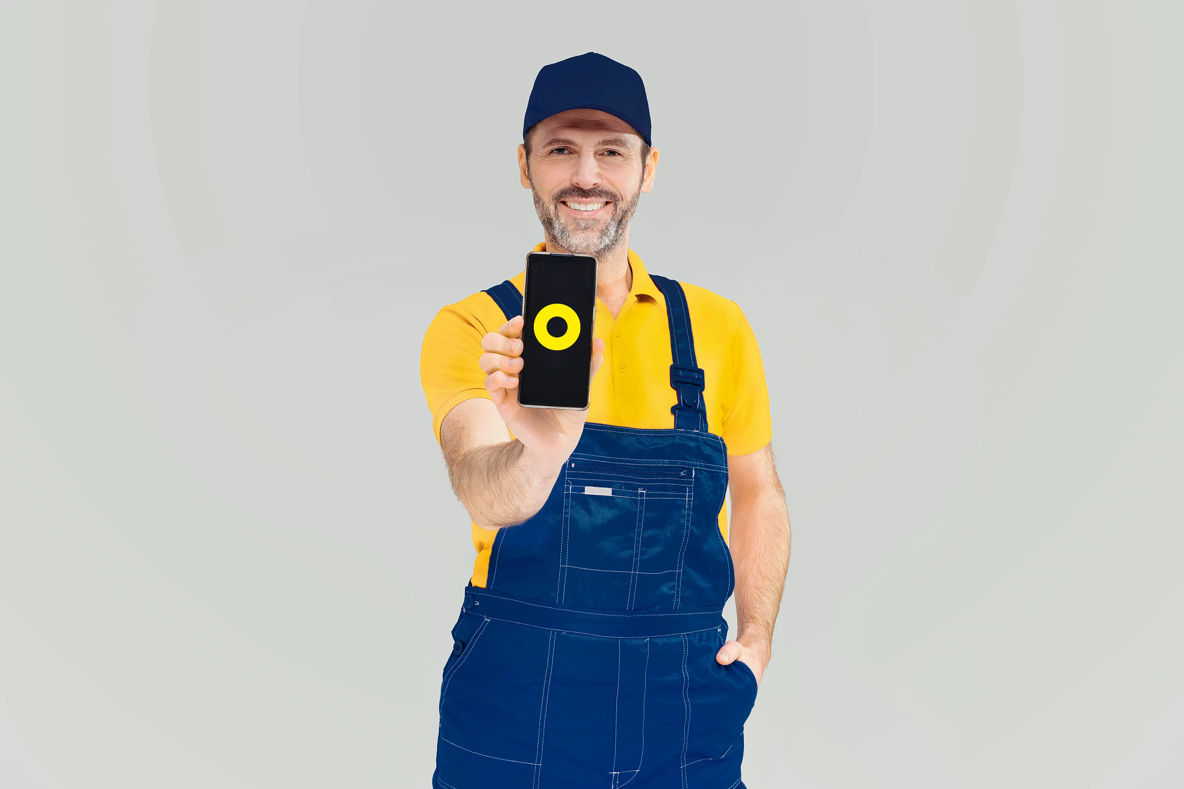 a person wearing working clothes, holding a smartphone with a yellow circle on the screen